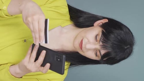 Woman Using Phone and Credit Card