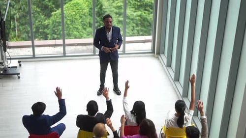Man Gives Presentation to Eager Audience at Office