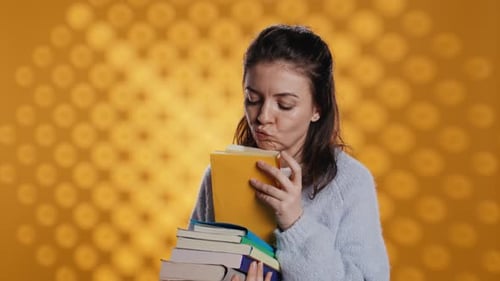 Woman Smiling While Sorting Colorful Books