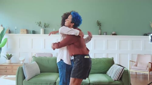 Friends Embrace Affectionately in Cozy Living Room