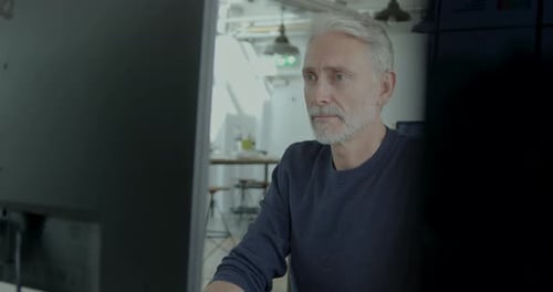 Senior Businessman Working in an Office on Desktop PC