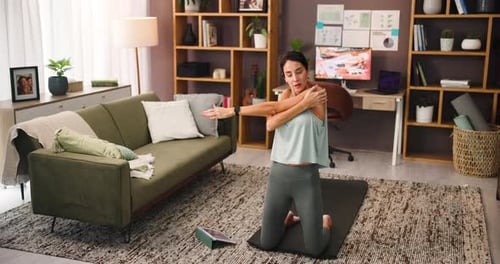 Woman Stretching Shoulders at Home on Yoga Mat