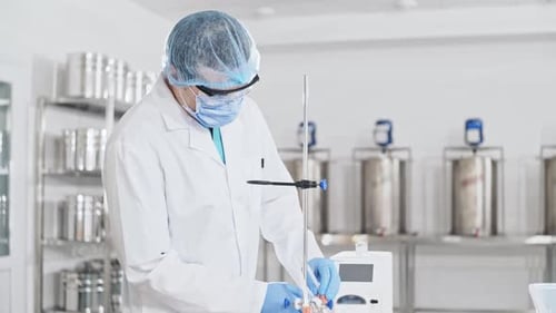 Scientist Working with Laboratory Equipment in Clean Room