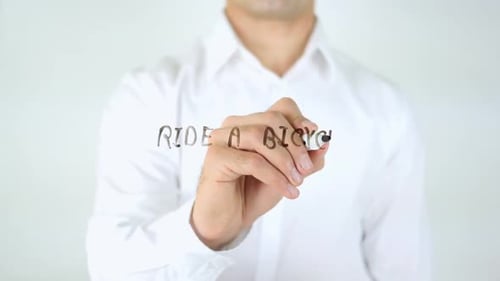 Man Writing Ride a Bicycle on Clear Surface