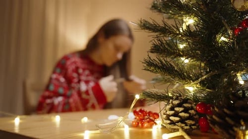 Woman Crafting Christmas Decorations at Home