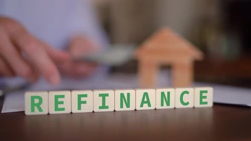 Person refinancing a mortgage on a property. Real estate refinance concept. Selective focus with man