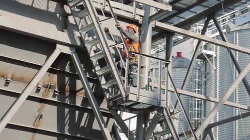 Engineer Working on Metal Structure at Industrial Facility