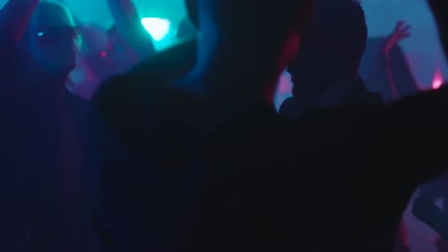Crowd of Young Adults Dancing at Nightclub