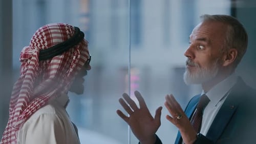 Two Businessmen Talking in Office Building