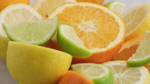 Fresh sliced citrus fruit assortment close up featuring oranges lemons and limes