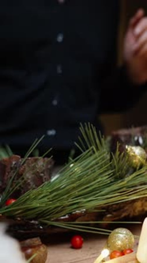 Arranging Christmas Centerpiece with Pine and Ornaments