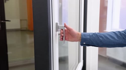 Friendly Manager in Window Shop Opens a Window