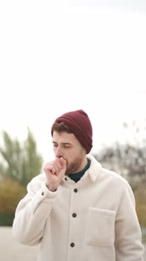 Young Adult Man Coughing and Blowing Nose