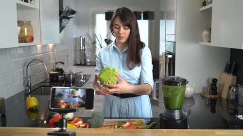 Woman Demonstrating Smoothie Recipe in Bright Kitchen