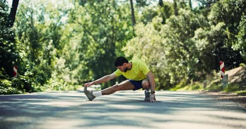 Young Man Stretching Leg on Road in Nature