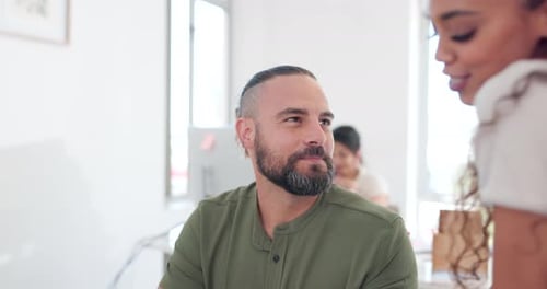 Man Talking to Woman in an Office Environment