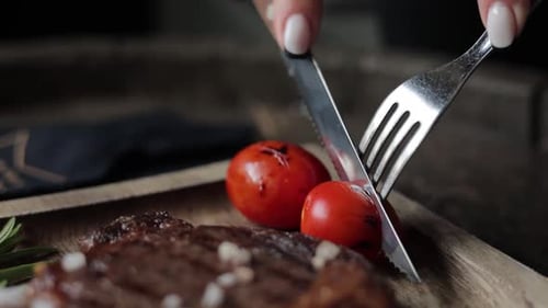 a restaurant guest cuts a steak