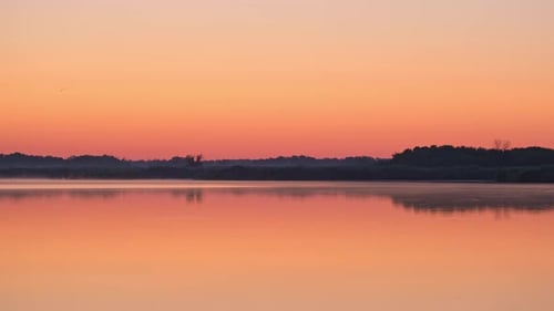 Sunrise. Nature background. Beautiful morning landscape. Foggy calm river with fog in golden sunligh