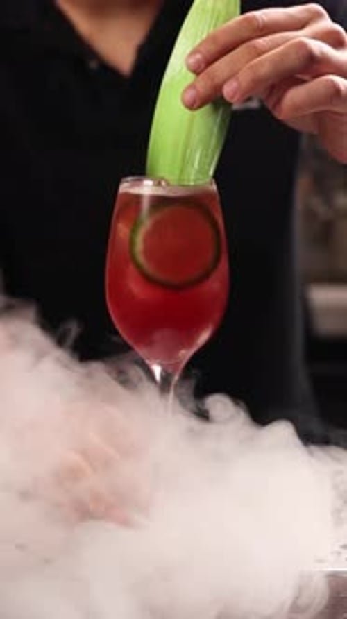 A bartender prepares an alcoholic cocktail at the bar. Close up