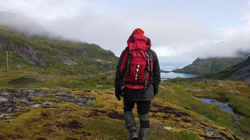 Young Traveler Walk at Famous Cliff Edge and Enjoying a Scenic View Over a Valley Lake and the