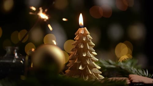 Christmas Tree Candle with Sparkler and Gold Bokeh