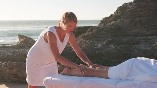 Caucasian Masseur Massaging Female Legs Outdoor