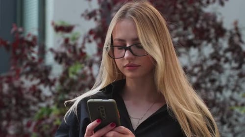 Woman Using Smartphone in City Setting