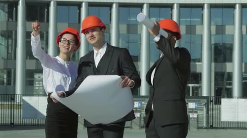 Engineers Discussing Plans at Construction Site