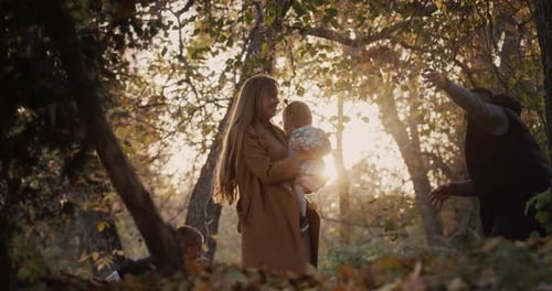 Family Have Fun in Autumn Park Throw Up Leaves Have a Good Time Together