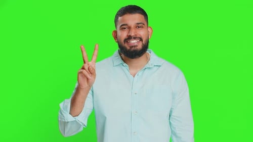 Man Smiling and Making Peace Sign on Green Screen