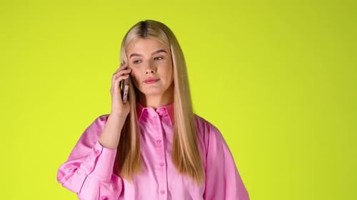 Young Blonde Woman Talking On Phone, Smiling and Laughing, Studio Shot