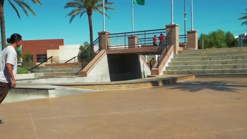 Teenage male Skateboarder at a Skate Park on Sunny Summer Day Riding on Skateboard, Slow Motion