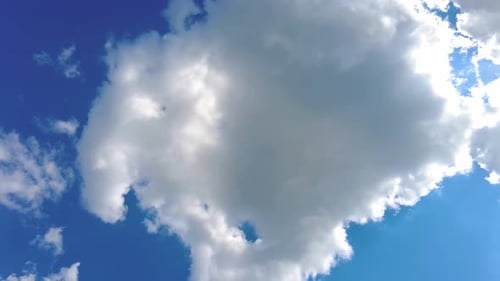 Fluffy White Clouds Float in a Blue Sky