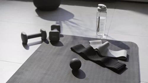 Fitness equipment on a yoga mat in a room
