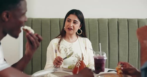 Woman, friends and conversation at lunch, restaurant and happy with funny memory, story or gossip