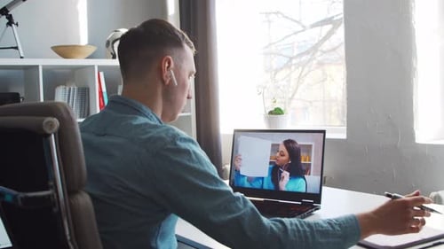 Man Attends Online Meeting in Home Office
