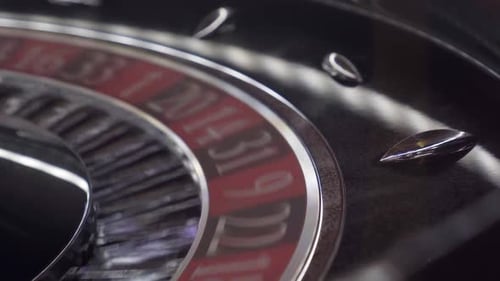 Close-up shot of a spinning casino roulette wheel showing the lucky ball landing on a random number.