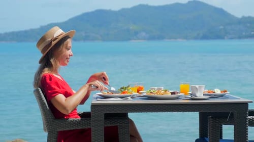 Woman Relaxes in Luxury Hotel Enjoying Sea View
