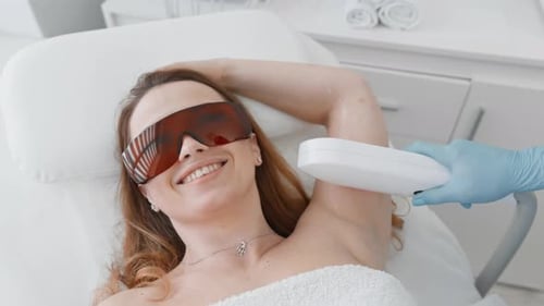 Woman Receives Laser Hair Removal in Clinic