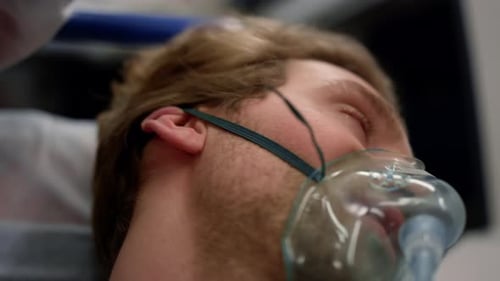 Coronavirus sick man receives emergency medical aid inside ambulance car