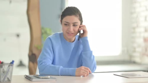 Indian Woman Talking on Phone in Office