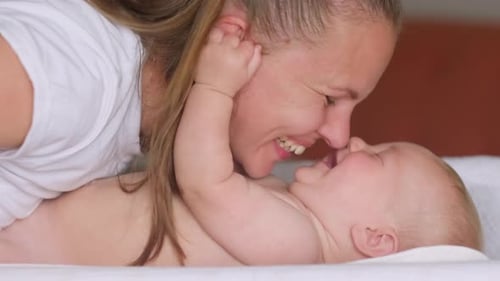Affectionate Mother Touching Noses With Baby