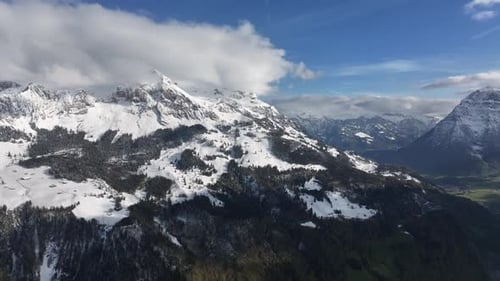 Majestic Snow Covered Mountain Peaks Under a Bright Blue Sky