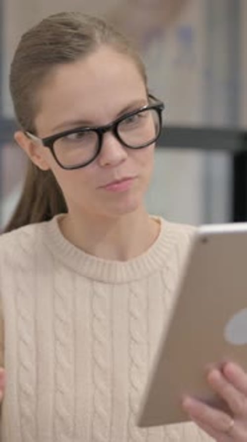 Smiling Woman Video Calling on a Tablet Device