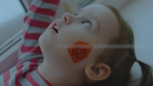 Cheerful Toddler Girl with an Email Symbol Painting on Her Face Communications Concept