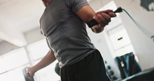 Hands, skipping rope or man jumping in gym with fitness for body, training
