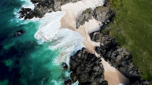Aerial view of wild rocky cliffs along the coastline in Iceland.