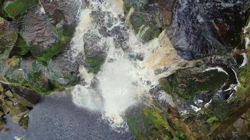 Aerial drone footage of a tall rocky waterfall in the Yorkshire Dales, Pennies. Moorland scene of a