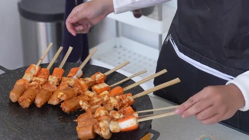 Young Woman Making Barbecue Suki Satay and Grilling Over A Hot Frying Pan
