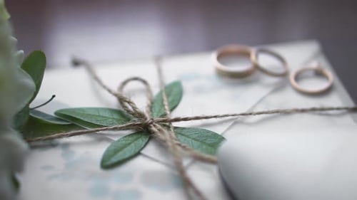 Close Up of Wedding Invitation and Rings
